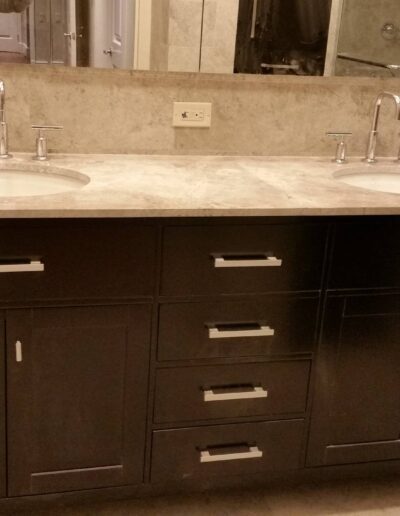 Modern double vanity with two sinks and storage cabinets in a bathroom.