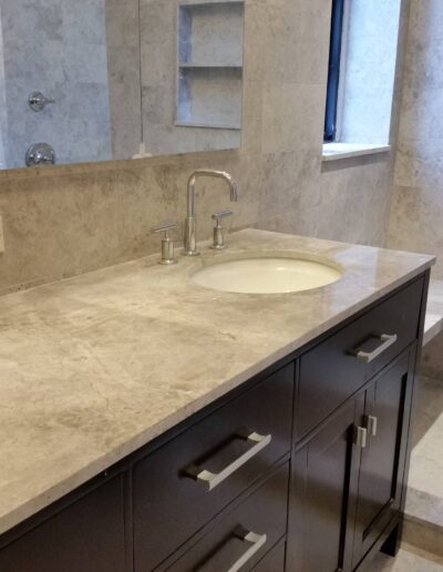 Modern bathroom vanity with marble countertop and undermount sink.