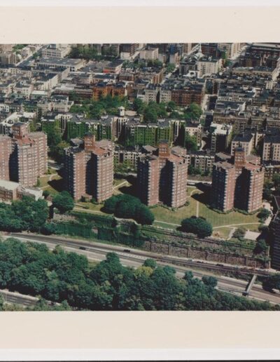 Aerial view of an urban area with apartment buildings and green spaces.