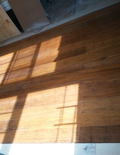 Sunlight casting window shadows on a wooden floor.