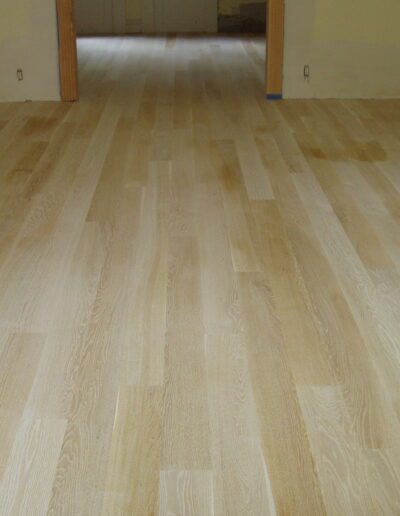 Light wooden flooring in an empty room.