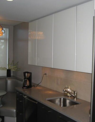 Modern kitchen with stainless steel appliances and pendant lighting.