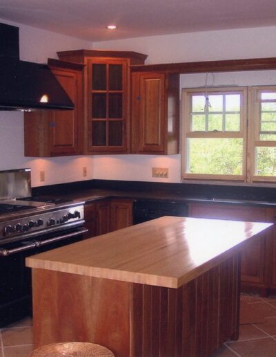 Modern kitchen with wooden cabinets and stainless steel appliances.