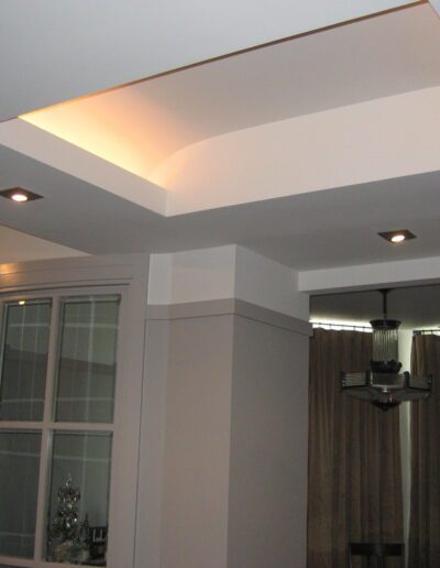 Modern interior with indirect ceiling lighting and column detailing.