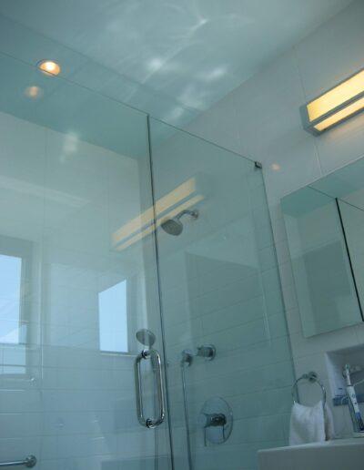 Modern bathroom interior with a glass shower enclosure.