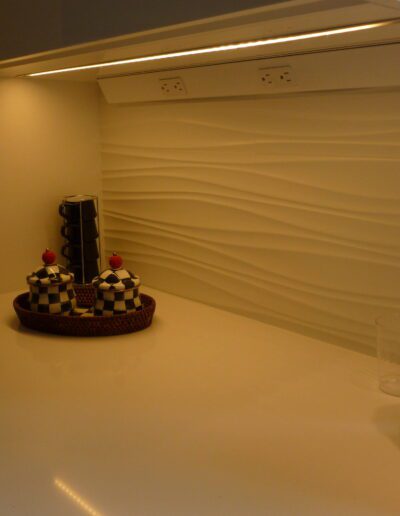 A modern kitchen countertop with a coffee maker, decorative baskets, and a paper towel roll.