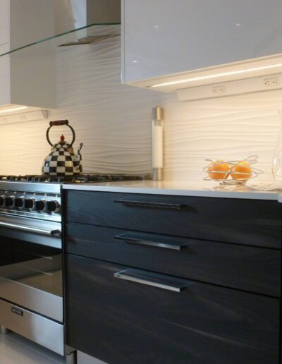 Modern kitchen interior with stainless steel appliances and dark wood cabinetry.