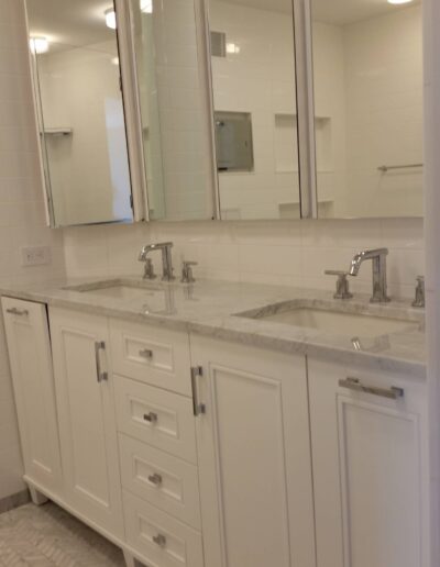 Modern bathroom interior with double sink vanity and large mirror.